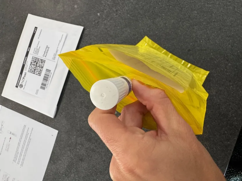 Placing the labelled DNA tube inside the biohazard bag