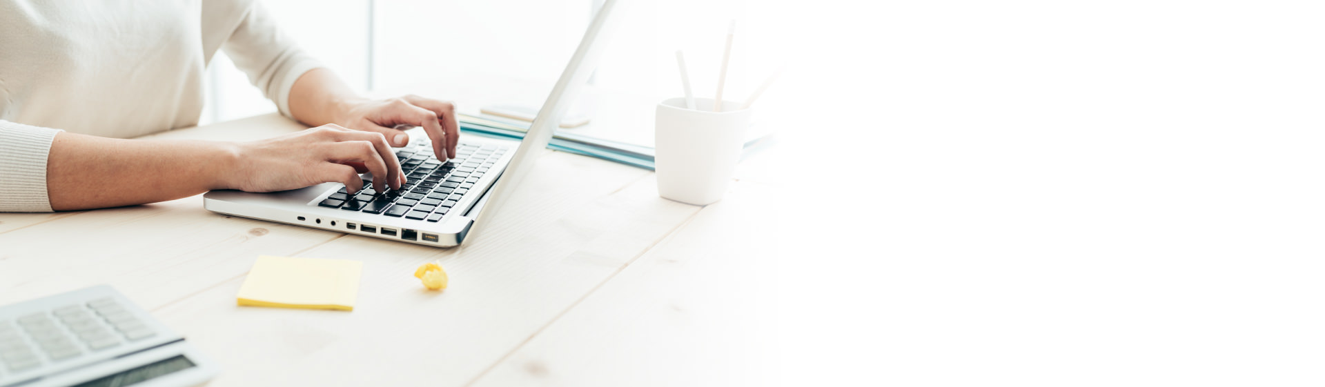 Image of a woman typing on a laptop